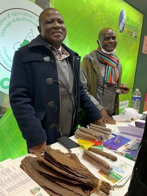 Le nouveau président de la chambre d’agriculture du Cameroun, M. Martin Mindjos (veste bleue), a conduit une forte délégation des producteurs au SIA. Ici il présente les cigares made in Cameroon. © Silas Bayebane